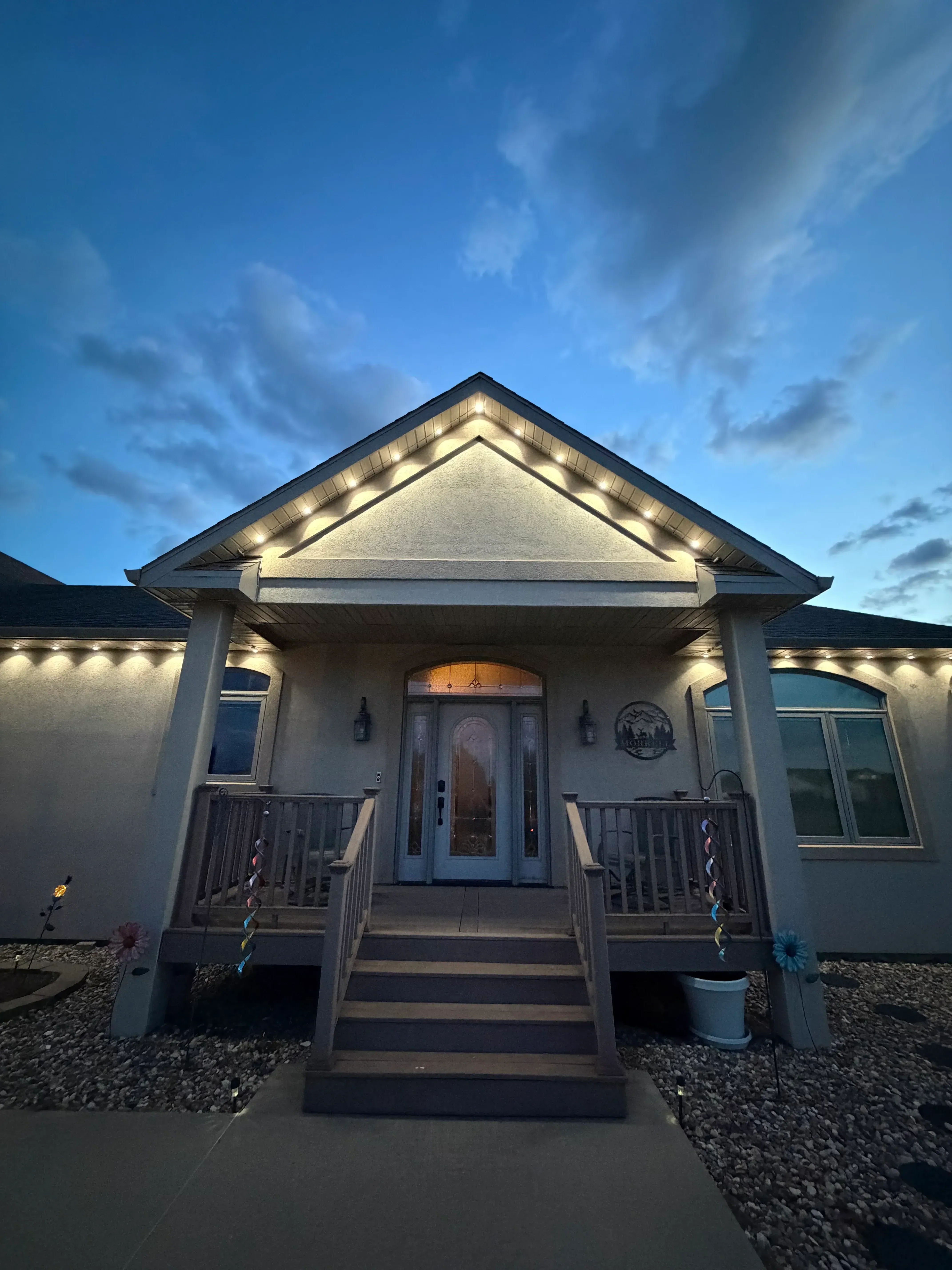 LED soffit and accent lighting installed on residential home exterior with stone facade