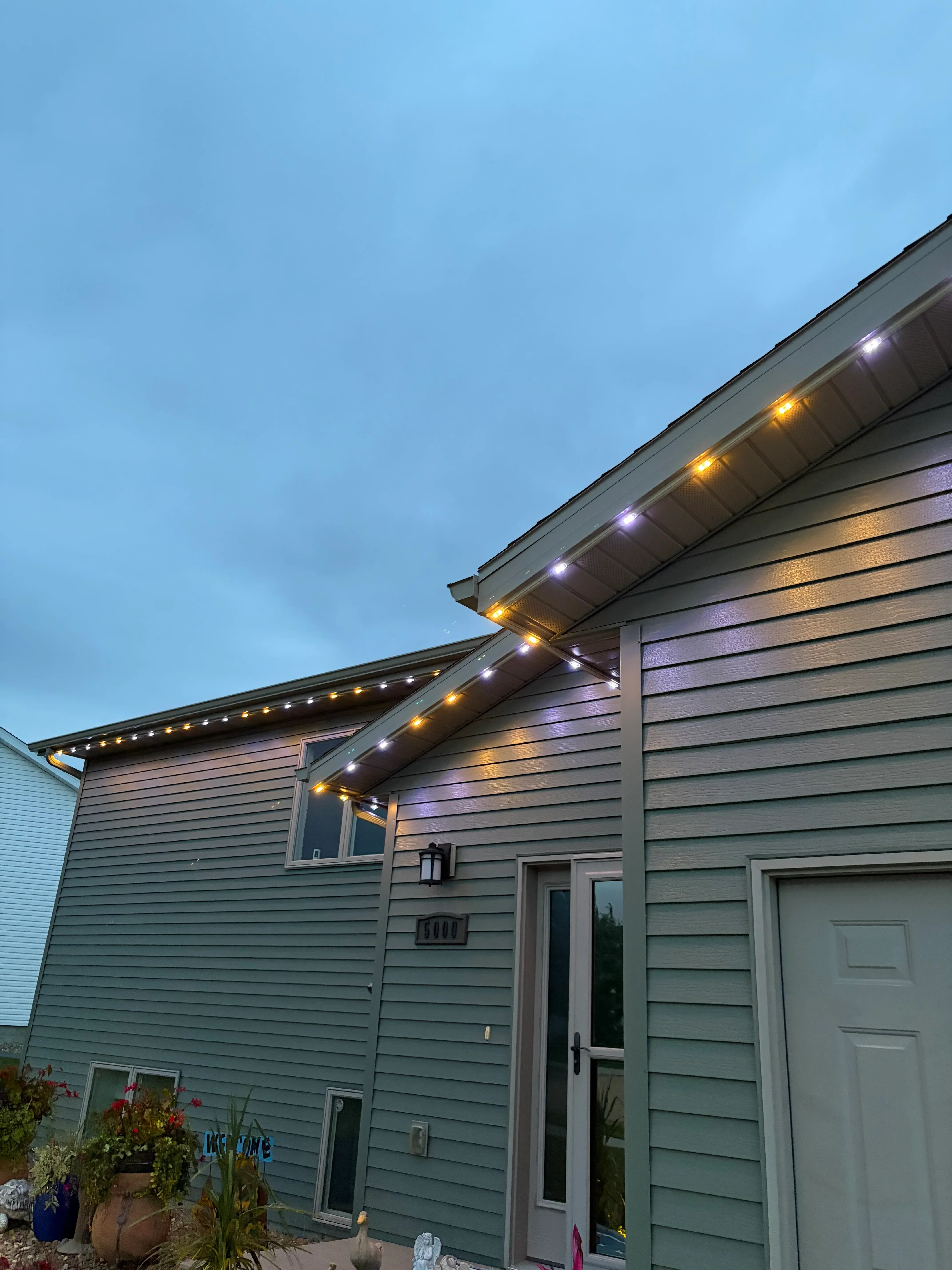 LED strip lighting installed on residential soffit and fascia with warm and cool white accent lights