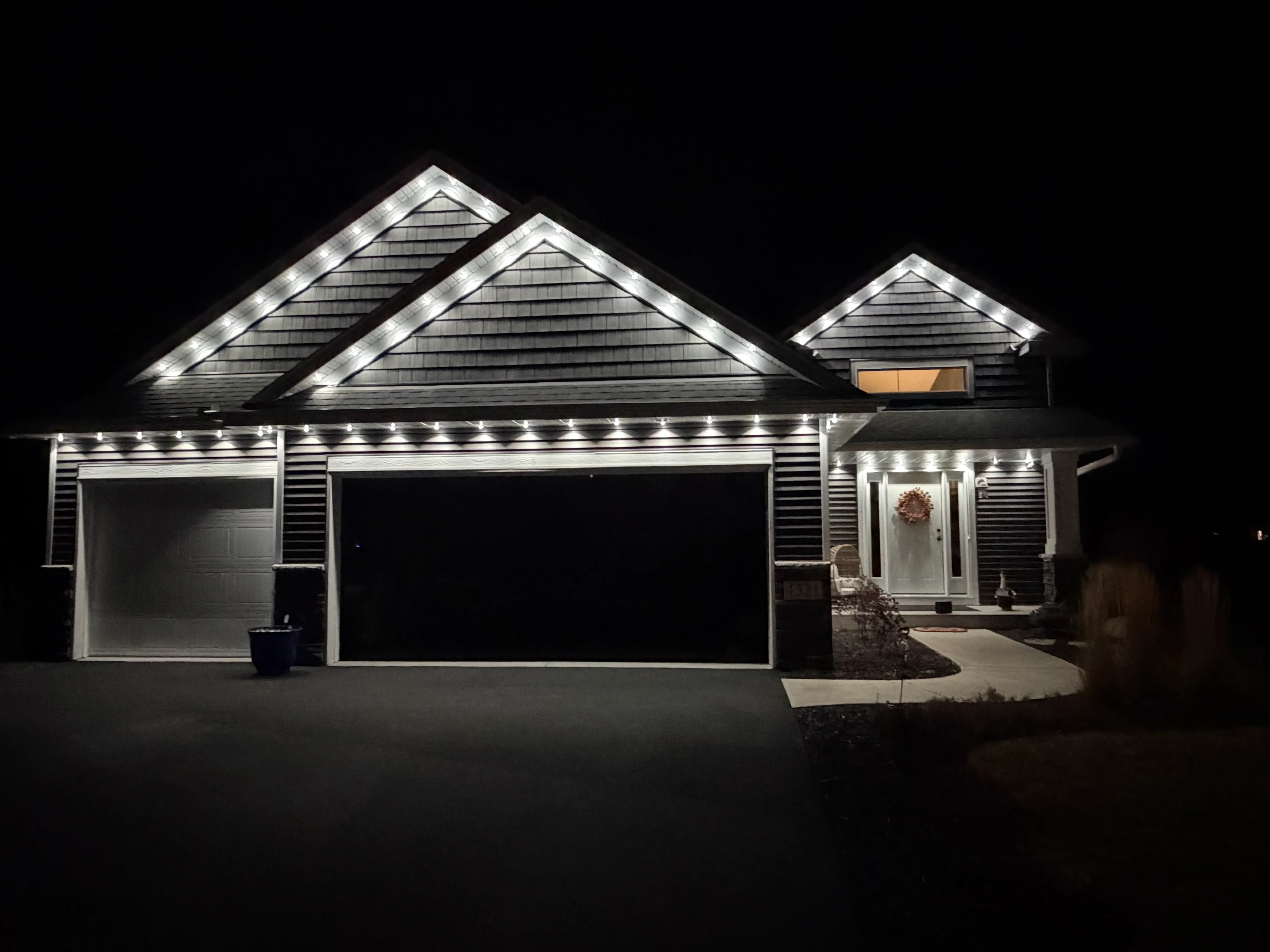 LED soffit and roofline accent lighting on residential home with gable highlights