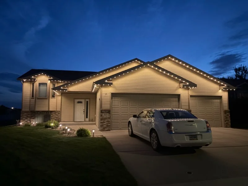 LED soffit and accent lighting on residential home exterior at dusk